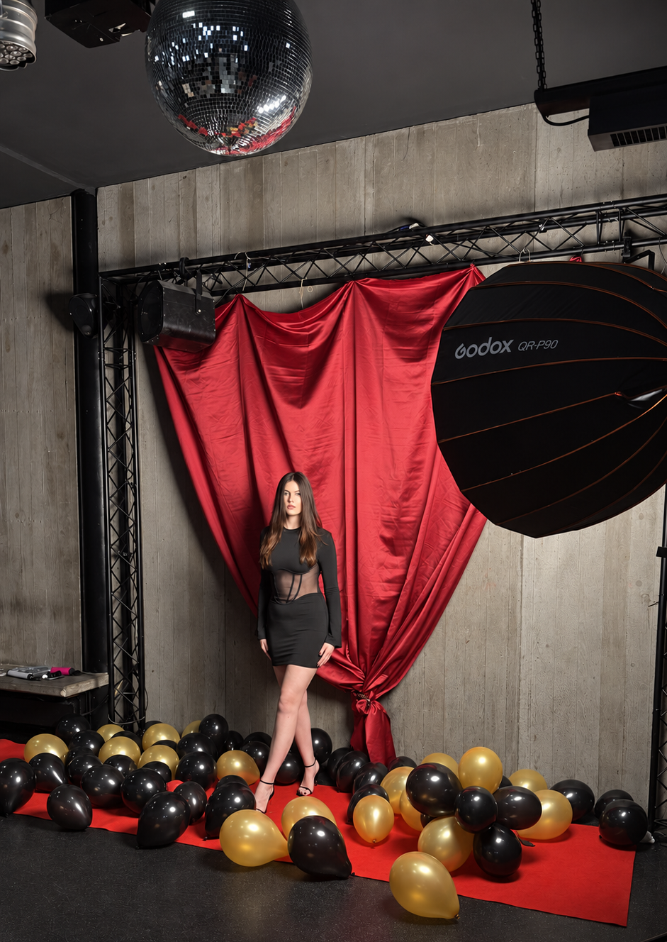Natalia in front of a red studio spotlight